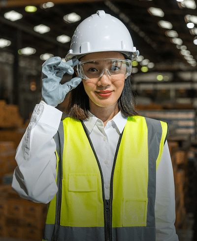 Woman in safety gear at warehouse.